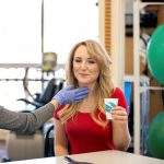 Female physical therapist testing female patients swallowing for rehab